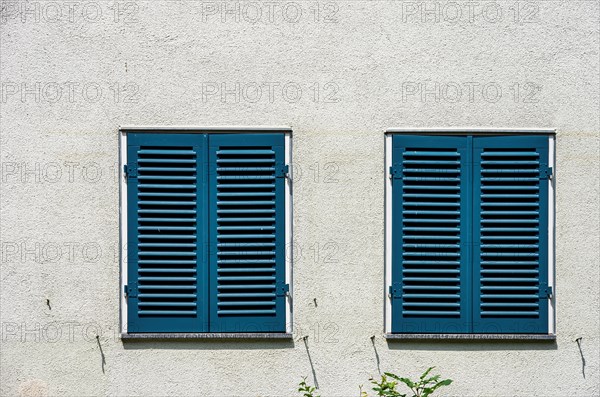 Two windows with closed shutters