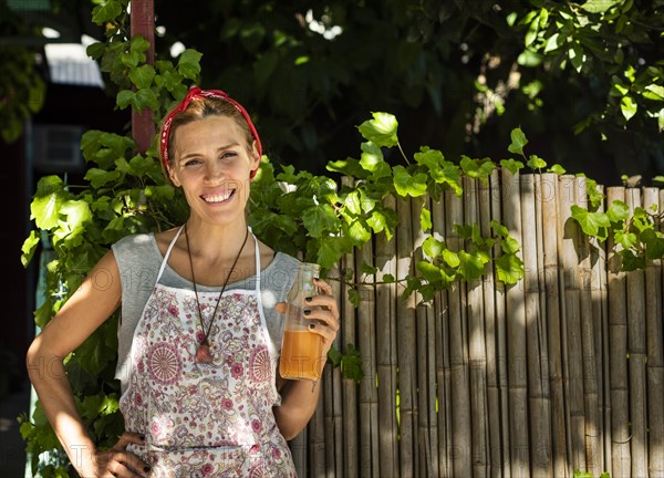 Smiling entrepreneur outisde her juice shop. Copy space