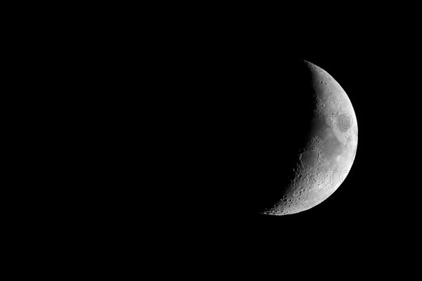 Waxing crescent moon seen with telescope