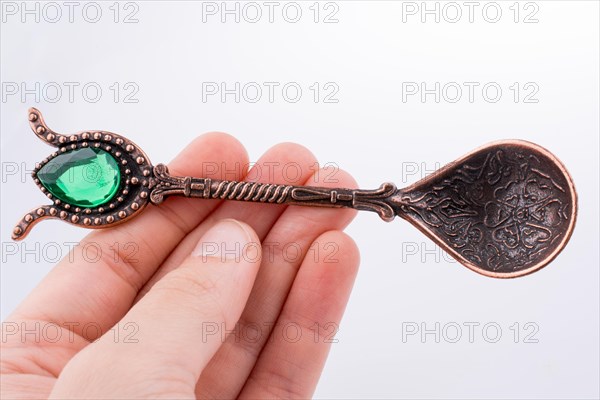 Hand holding a Retro styled teaspoon