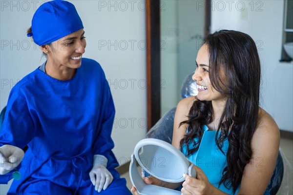 Female dentist talking to her patient at dentist's office. Concept of whitening