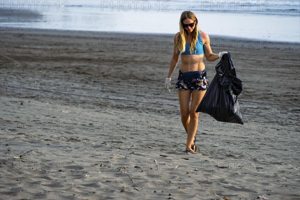 The problem of environmental pollution. Cleaning up trash on the beach