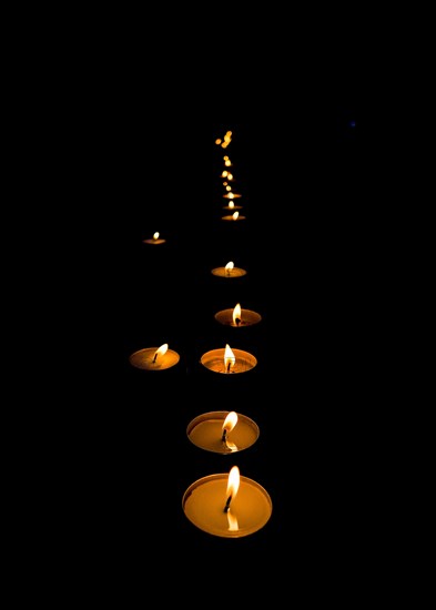 Lit candles in the dark