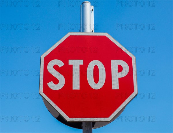 Stop sign over blue sky