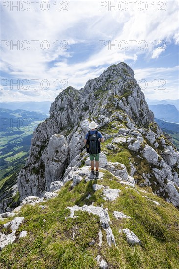 Mountaineer on a narrow ridge path