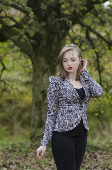 Sad young woman standing in the countryside