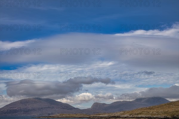 View from the sandy Luskentyre Beach over the sea bay East Loch Tarbert to the mountains