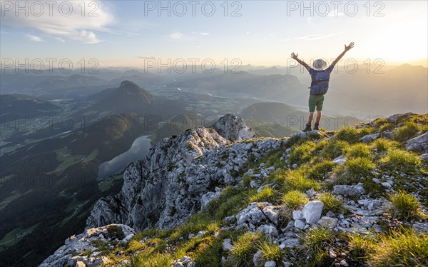 Mountaineer stretching his arms in the air