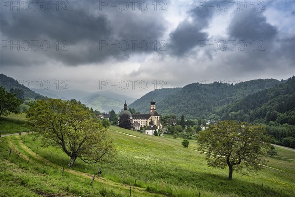 Thunderclouds pass over the Muenstertal and the monastery of Sankt Trudpert