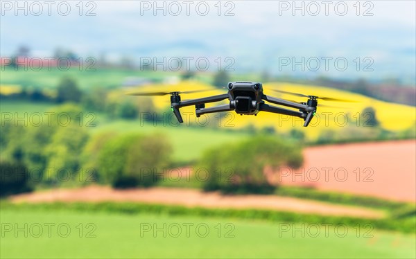 Drone in flight over fields and farms