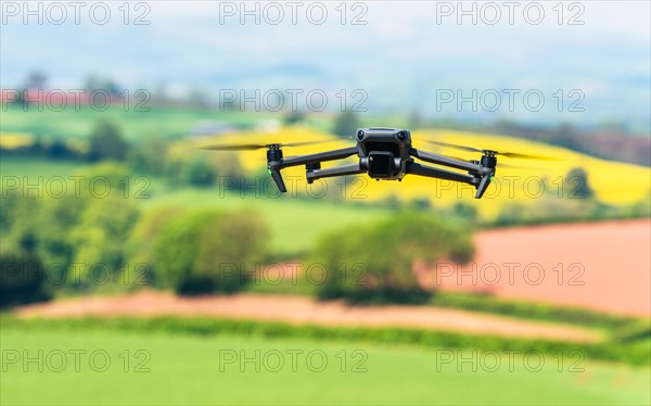 Drone in flight over fields and farms