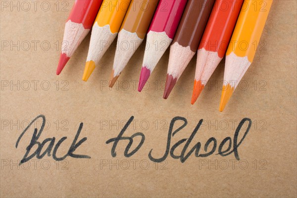 Color pencils and back to school title on a notebook