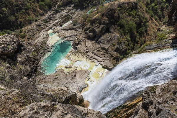 Huge waterfall with turquoise rockpools