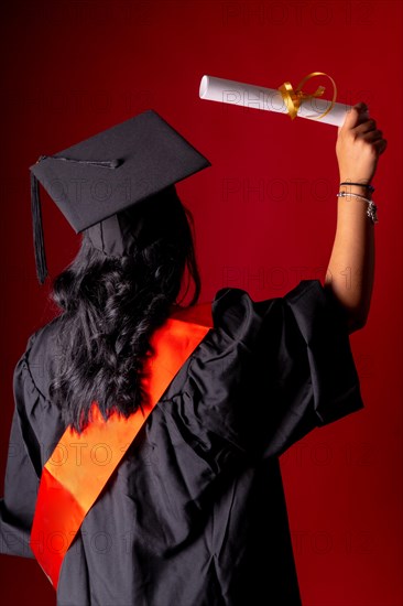 Female student in a graduation photo. End of education degree with graduate diploma. University