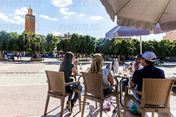 People sitting at cafe in main square