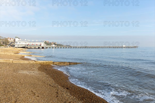 Groynes shingle beach and pier on seafront