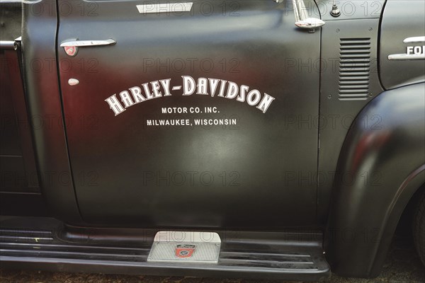 Advertisement for Harley Davidson on the car door of a 1953 Ford F100 V8