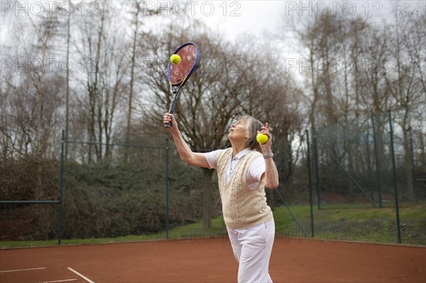 Subject: Woman aged 83 standing on the tennis court.