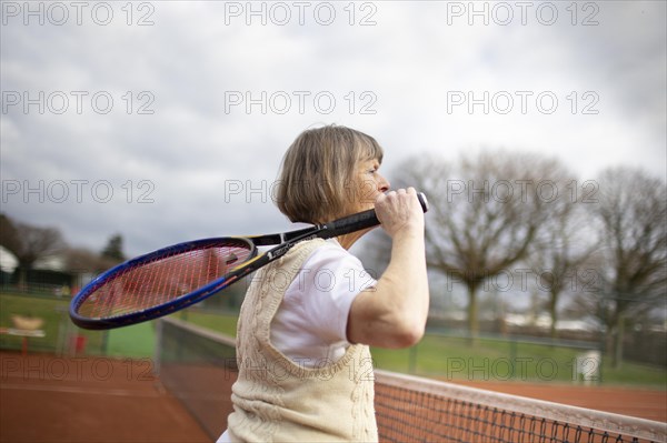 Subject: Woman aged 82 standing on the tennis court