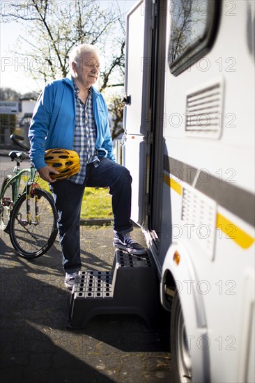 Subject: Pensioner goes into his caravan.