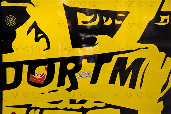 Black and yellow graphic with graffiti impression in front of the BVB FanWelt of Borussia Dortmund