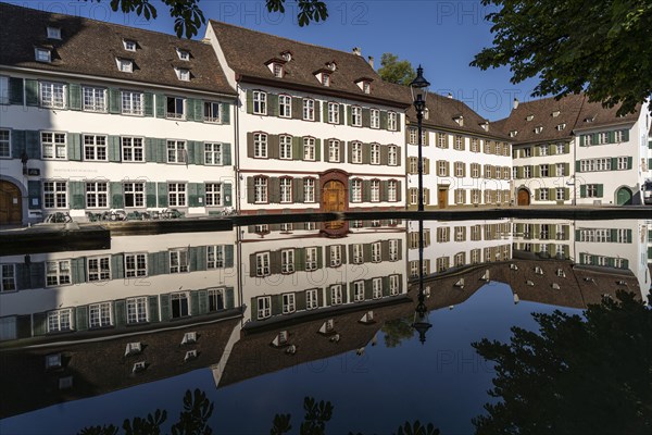 Cathedral houses reflected in the fountain on Muensterplatz in Basel