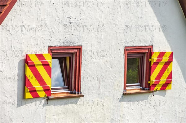 Window with colourfully painted shutters