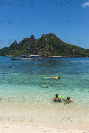 Tourists enjoying the beautiful clear turquoise waters of Monuriki or Cast away island