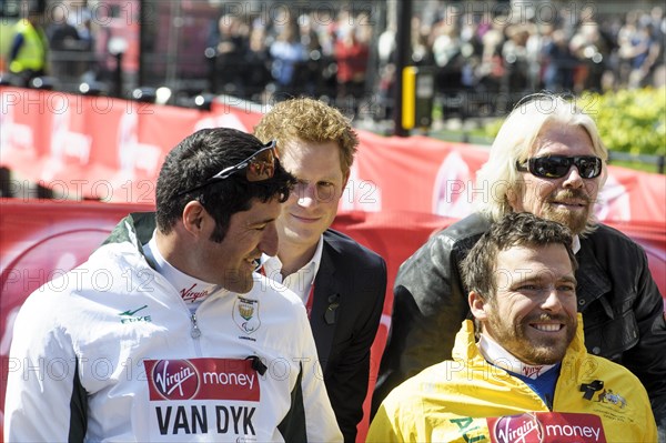Prince Harry presents a medal to the Mens Elite Wheelchair winner Kurt Fearnley at the Virgin London Marathon Medal Presentations on 21.04.2013 at The Mall