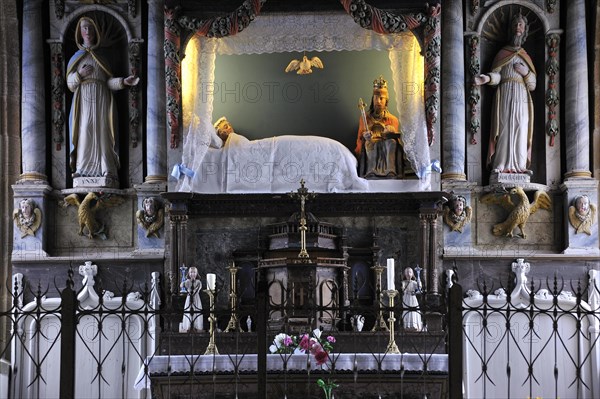 Interior of the chapel chapelle de la Vierge couchee with the sleeping Virgin Mary in bed