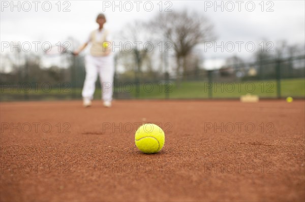 Subject: Woman aged 82 standing on the tennis court