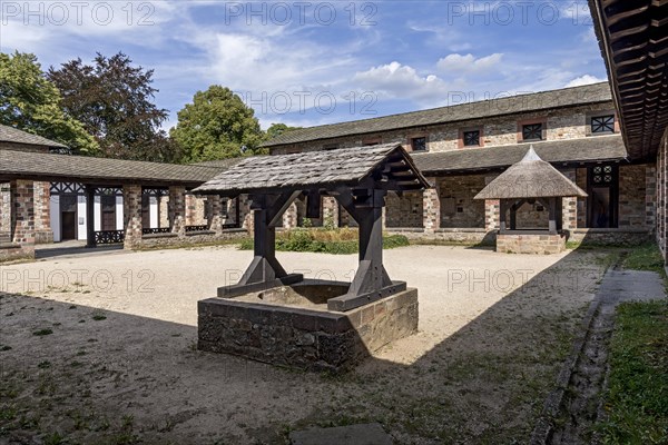 Well house with wooden roof and thatched roof