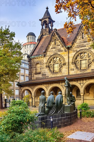 Court of honour with arcades and group sculpture of the Consoling Christ by Selmar Werner. The church