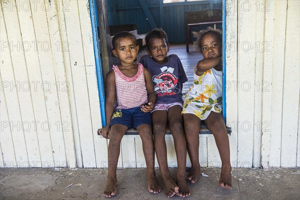 School kids sitting in the entrance of a school