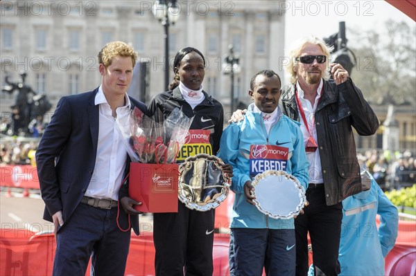 Prince Harry presents medals to the Elite mens and womens winners Tsegaye Kebede and Priscah Jeptoo at the Virgin London Marathon Medal Presentations on 21.04.2013 at The Mall