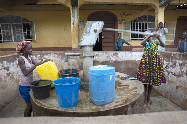 Bomeh Village at the KissyRoad dumpsite. Girls at the water pump that only delivers toxic water