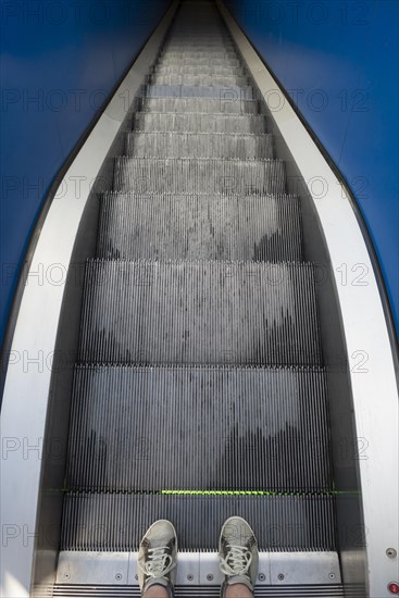 Man standing on a escalator
