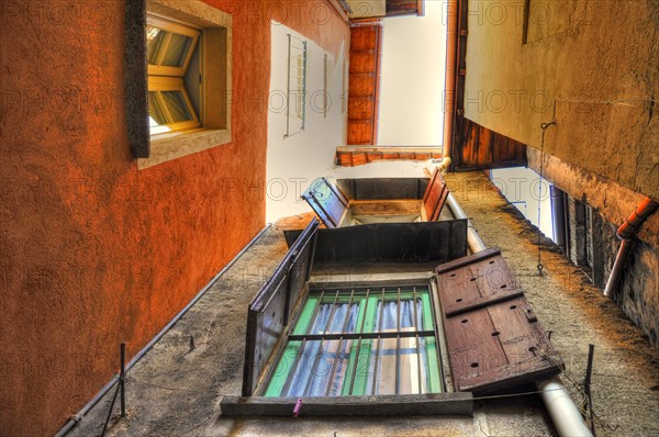 Narrow Patio Between Houses with Windows and Sky in Cannobio