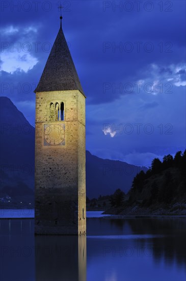 The submerged church tower at night in Lago di Resia at Curon Venosta