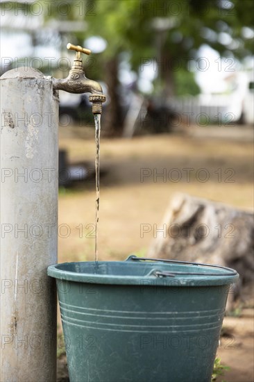 Water. Water bucket and running tap in Lome