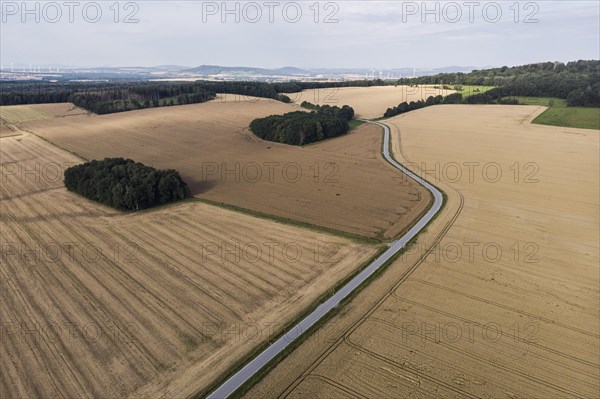Aerial view of a country road with a red car in Koenigshain in Saxony.