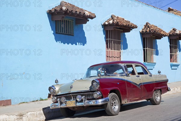 Pastel coloured house and old 1950s vintage American car