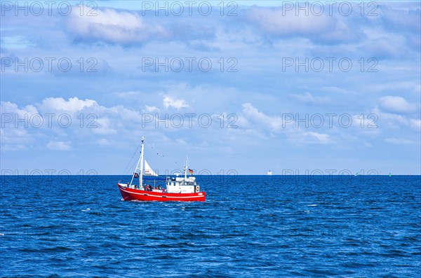 The fishing vessel PASEWALK leaves the harbour entrance with passengers and with a hoisted pirate flag towards the open sea