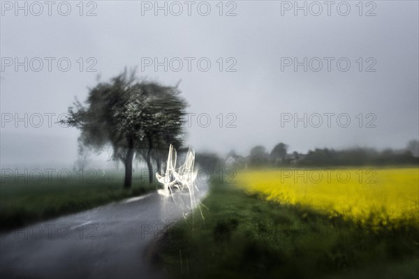 A car stands out through a wet window in Vierkirchen