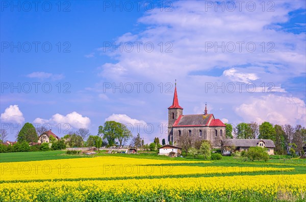 Beautiful depiction of the Church of St. John the Baptist in its rural setting in Ujezd pod Troskami