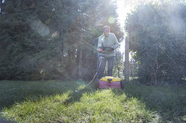 Subject: Man tends his lawn.