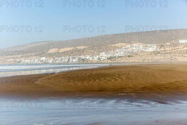 Sandy beach at low tide near village of Taghazout