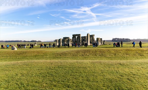 Tourists view standing stones of Neolithic henge