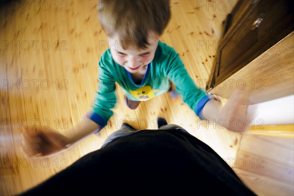 Symbolic photo on the subject of children's tantrums. A boy beats his father with his fists. Berlin