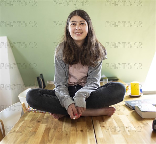 Subject: Girl sitting on a table